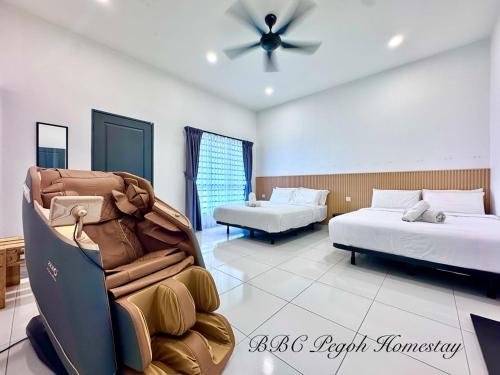 a bedroom with two beds and a ceiling fan at BBC Pegoh in Ipoh