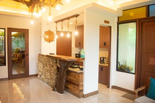 a kitchen with a log counter in a house at Katunggan Cove Resort in Nueva Valencia