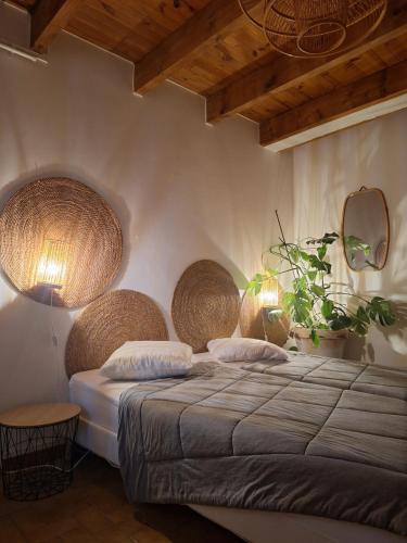 a bedroom with a bed with baskets on the wall at La Cadette des 2 Frangines in Mazeyrat-Aurouze