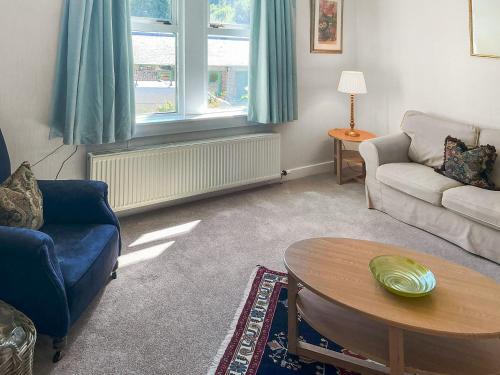a living room with a couch and a table at Rose Cottage - Uk52178 in Leven
