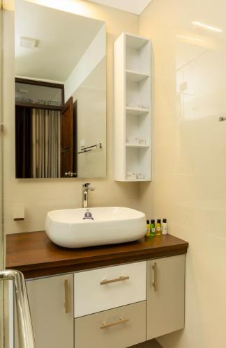 a bathroom with a sink and a mirror at Villa Oasis in Kataragama