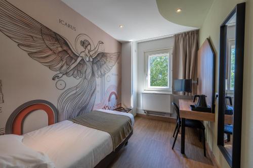 a bedroom with a bed with an angel mural on the wall at Hôtel Icare in Toulouse