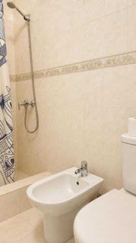 a bathroom with a toilet and a sink and a shower at Pôr do Sol in Vila Nova de Gaia