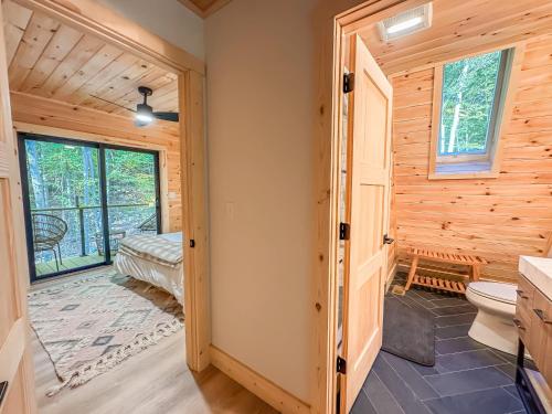 a bathroom with a toilet and a bedroom with a window at Stunning New Construction Modern Beautiful in McHenry
