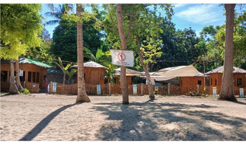 a no parking sign in front of some trees at Point Calixto beach front hut, Boracay in Boracay