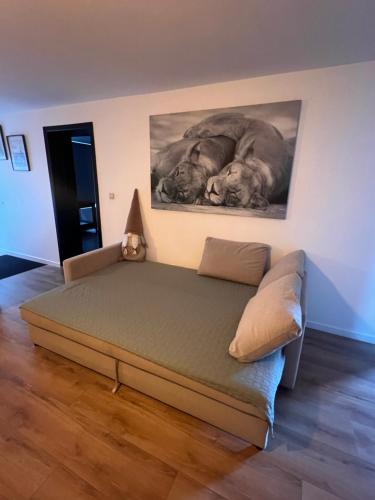 a bedroom with a bed and a painting on the wall at Résidence du Moulin 2-C Proche de Pairi Daiza - Parking Gratuit in Boussu