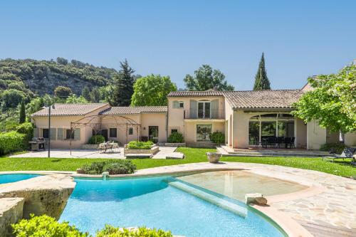 a house with a swimming pool in the yard at La Cascade des Souvenirs Vacation rental just a short walk from Vaison in Vaison-la-Romaine
