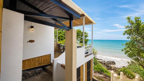 a house on the beach with a view of the ocean at Moonlight Bay Resort in Ko Lanta