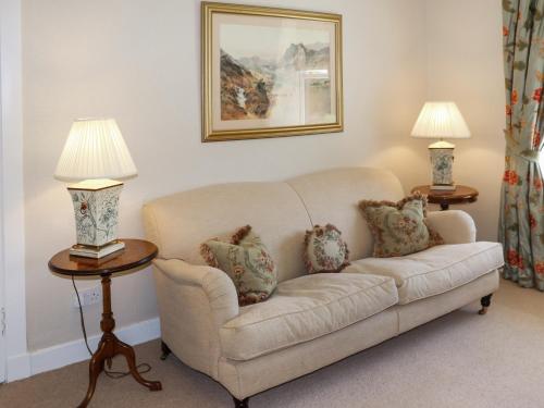 a living room with a couch and two lamps at Heather Cottage - Uk52177 in Leven