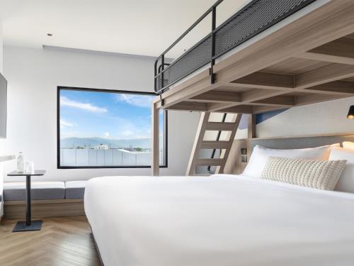 a bedroom with a bunk bed and a staircase at Bedz Hotel Ban Bueng in Ban Bung