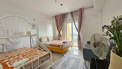 a bedroom with a bunk bed and a couch at VFeel at Home- 2 BR Unit in Baguio
