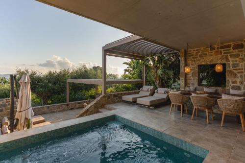a swimming pool in a villa with a patio at Gialova Hills - Luxury Villa with Private Pool, Sauna, Garden & Seaview in Gialova