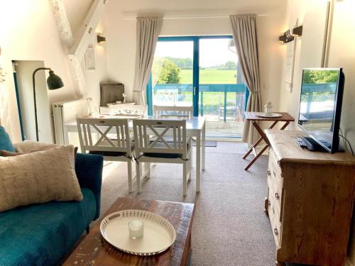 a living room with a couch and a table at Ferienwohnung Kalleby 26 in Quern