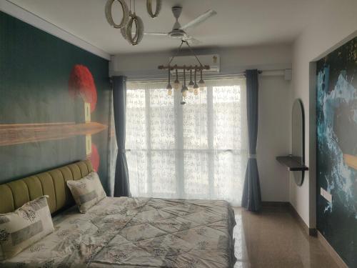 a bedroom with a bed and a ceiling fan at 2BHK Luxurious Apt near BKC in Mumbai