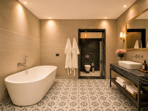 a large bathroom with a tub and a sink at Chandralok - A Boutique Hotel in Udaipur Near Fateh Sagar Lake in Udaipur