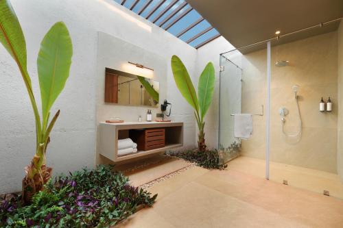 a bathroom with a shower and a sink and a mirror at Ayati Resort & Spa in Panchgani