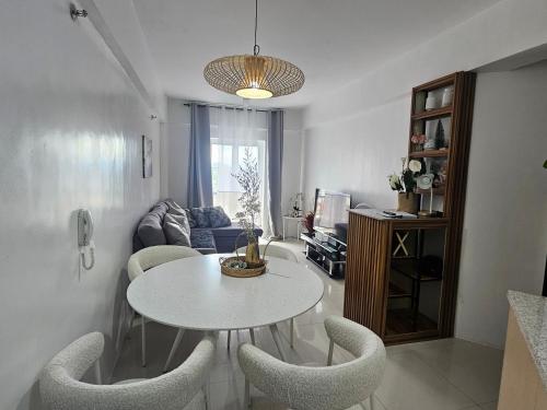 a living room with a white table and chairs at VFeel at Home- 2 BR Unit in Baguio