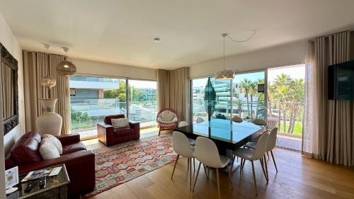 a living room with a glass table and chairs at Prime - Shared Pool - 6 Guests - Albufeira in Albufeira