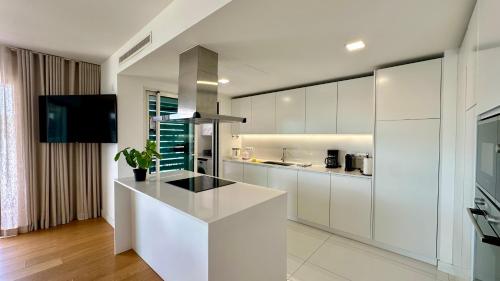 a kitchen with white cabinets and a counter top at Prime - Shared Pool - 6 Guests - Albufeira in Albufeira