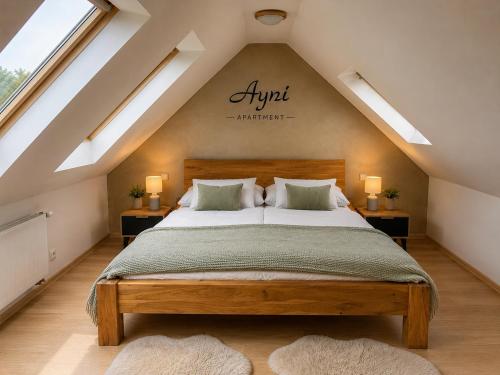 a bedroom with a bed in a attic with skylights at Ayni Apartment Semily in Bohemian Paradise in Semily
