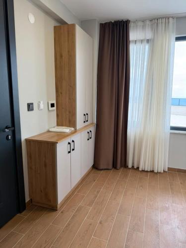 a room with white cabinets and a large window at Mimoza Apart in Trabzon