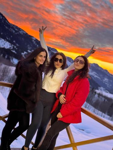 three women standing on a fence in the snow at Mountain View in Goderdzi