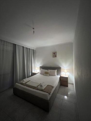 a bedroom with a large bed and two night stands at KallitheaDeluxe in Kallithea Halkidikis