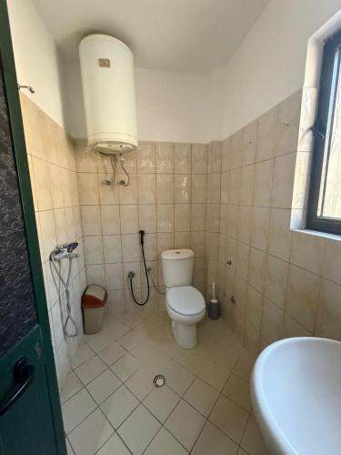 a bathroom with a toilet and a sink at Sun & Sea Shengjin in Lezhë