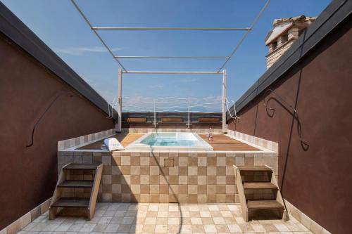 a swimming pool on the roof of a building at Massoni Wine Relais in Peschiera del Garda