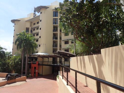 a building with a balcony in front of it at Darwin Deluxe Apartments in Darwin