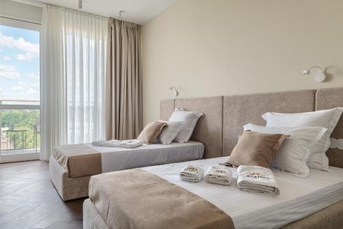 two beds in a room with a window at Azamra in Uman