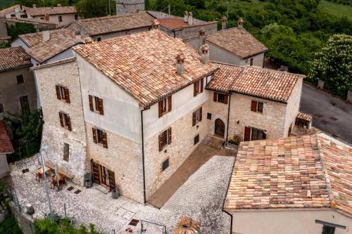 an aerial view of a large stone building with tile roofs at Turris Morro di Rasiglia in Rasiglia