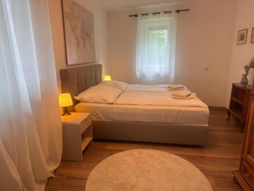 a small bedroom with a bed and a window at Apartment Ischl Home in Bad Ischl