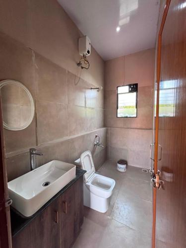 a bathroom with a sink and a toilet at Roots in Pune