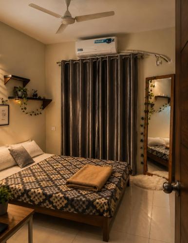 a bedroom with a bed and a large window at Coutinho BNB in Madgaon