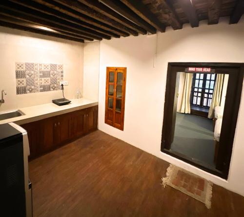 a room with a kitchen with a sink and a window at Newa Inn Homestay in Kathmandu