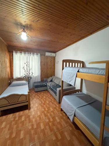 a room with two bunk beds and a couch at Sun & Sea Shengjin in Lezhë