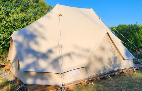 a large tent is sitting in the grass at Nid et Toiles in Bernadets-Debat