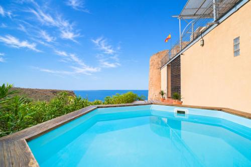 a swimming pool with a view of the ocean at Mirador Torre de la Garrofa in Almería