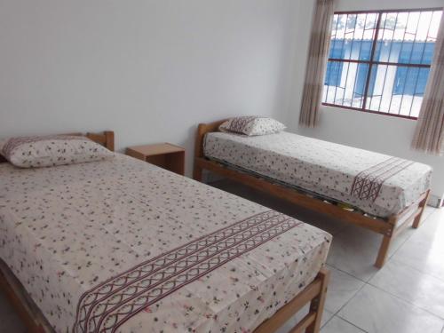 Ένα ή περισσότερα κρεβάτια σε δωμάτιο στο Hospedaje Marvento