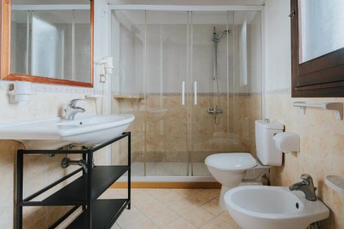 a bathroom with a sink and a toilet and a shower at Dimora La Vignazza in Marzamemi