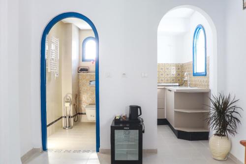 a bathroom with a sink and a toilet and a mirror at Dar Beate Sousse Medina in Sousse