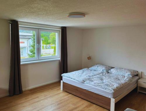 a bedroom with a bed and a window at Apartmán Zulu in Liptovský Mikuláš