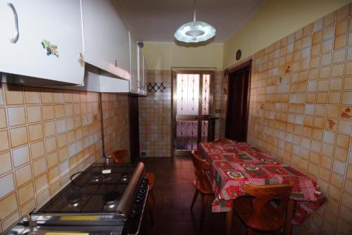 a kitchen with a table and chairs and a stove at I due cipressi in Cagli