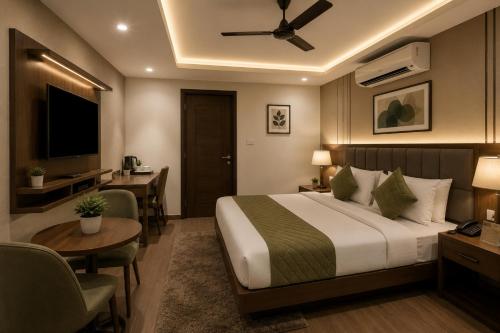 a hotel room with a bed and a table and a desk at Hotel Starlin Near Delhi Airport & Free Airport pickup in New Delhi