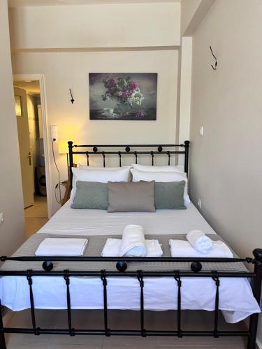 a bedroom with a bed with towels on it at Almyra Home in Kyparissia