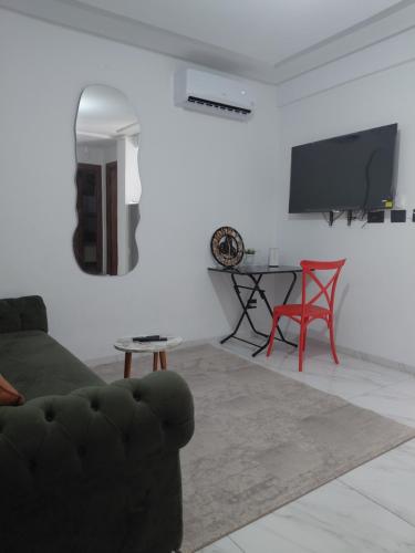 a living room with a couch and a table at La perle in Sukrah