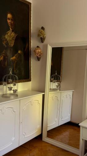 a room with a painting of a man with two birds at Garden Apartment in Baden-Baden