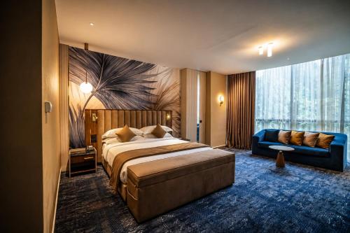 a hotel room with a bed and a couch at Hotel Supreme in El Biar