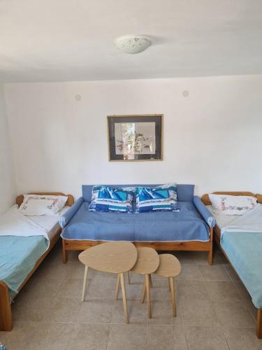 a room with two twin beds and a table and a table at Sea view house Zagradje in Bar